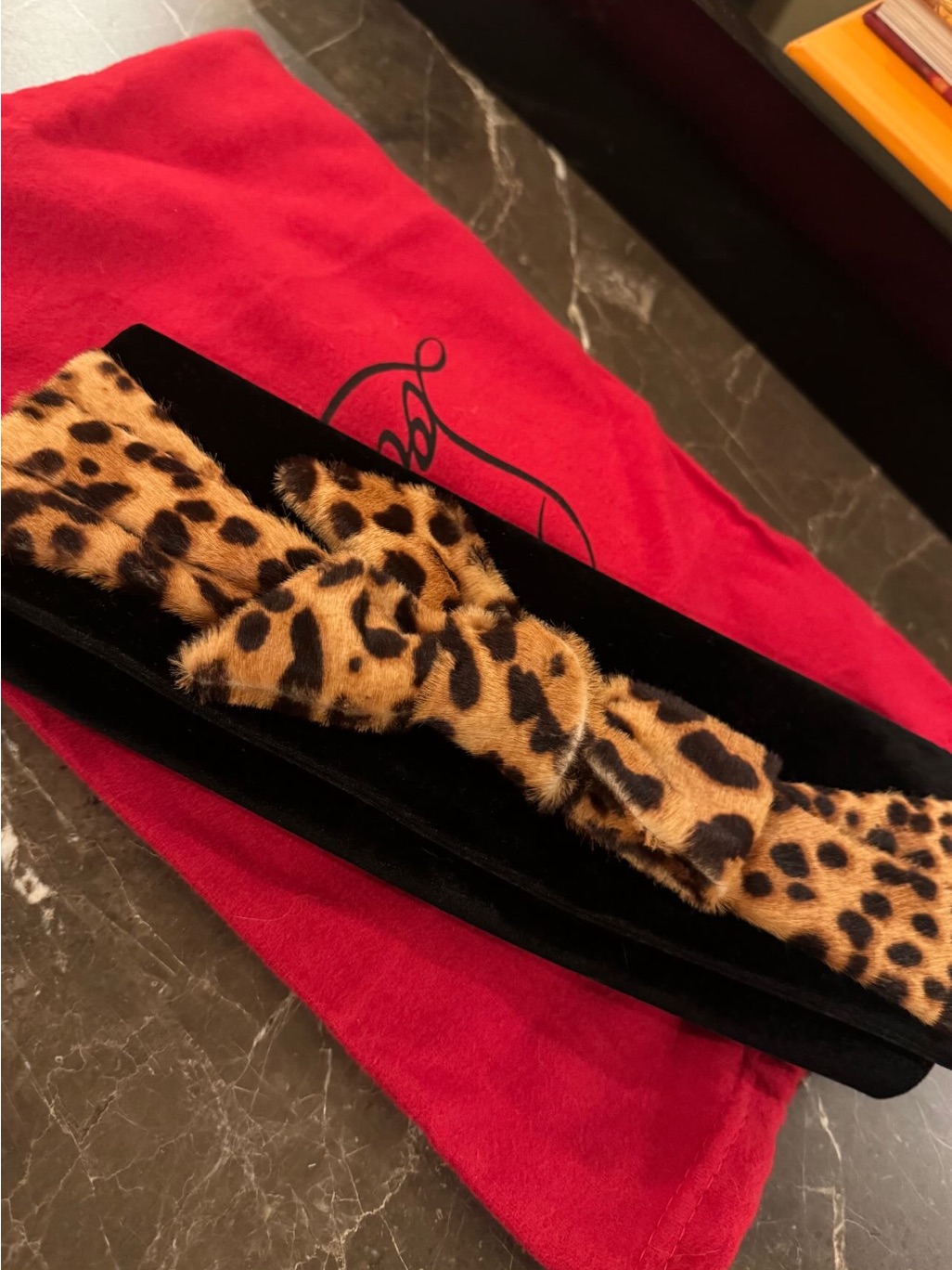 Loubitin Leopard Print Bow Clutch On Black Velvet